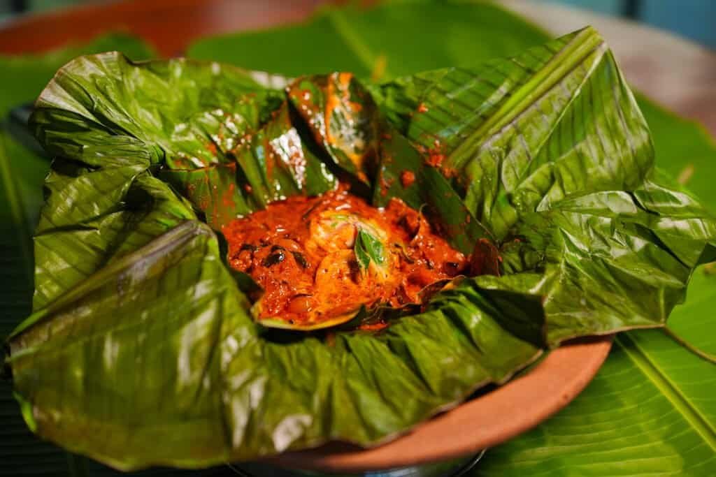 Spicy Kerala food served on banana leaf at Spice Aromas restaurant on the Munnar.
